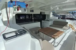 Spacious deck of 2020 Lagoon 46 catamaran with seating and table.