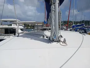 Sailing catamaran Leopard 40, 2021 model, docked in a marina under cloudy skies.