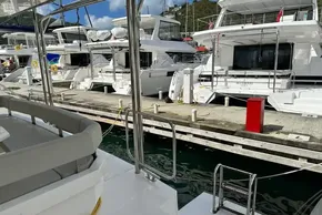 Docked 2025 Robertson and Caine Leopard 46 Powercat yachts in a marina.