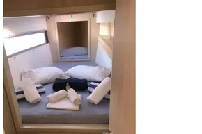 Cozy cabin interior of 2020 Leopard 40 yacht with neatly arranged bedding and towels.