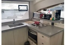 Modern kitchen interior on a 2020 Leopard 40 catamaran with appliances and ocean view.