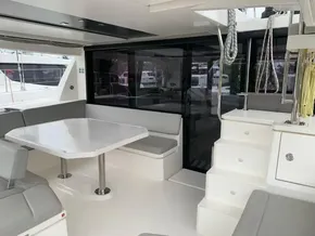 Interior of 2021 Leopard 45 catamaran with modern seating and dining area.