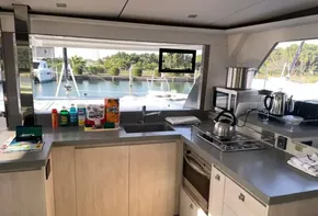 Modern kitchen interior on a 2021 Leopard 45 yacht with appliances and marina view.