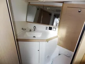 Modern bathroom in 2020 Beneteau Oceanis 46.1 yacht with sink and mirror.