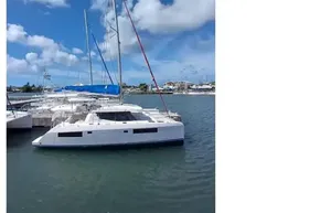 2018 Leopard 45 catamaran docked in a sunny marina with blue skies.