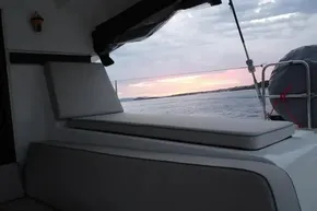 2024 Lagoon 42 yacht interior with sunset view over the ocean.