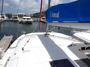 Leopard 40 catamaran docked at marina, featuring Sunsail branding, under a clear sky.