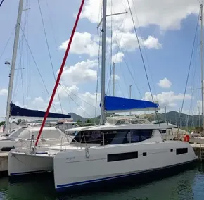 2019 Leopard 45 catamaran docked at marina under blue sky.