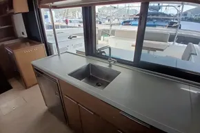 Modern kitchen interior of 2020 Lagoon 46 yacht with sink and window view.