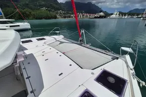 2021 Leopard 45 catamaran docked in scenic marina with mountains in background.