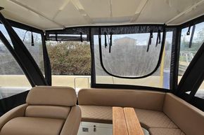 Interior of 2023 Balt 818 Titanium boat with beige seating and clear windows.
