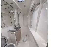 Modern yacht bathroom with toilet, sink, and shower in a 2019 Leopard 50 model.
