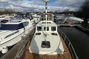 Linssen 360 AC 1994 yacht docked among other boats on a cloudy day.
