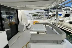 2025 Robertson and Caine Leopard 46 Powercat yacht with spacious outdoor seating area at marina.