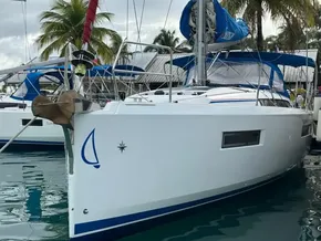 2019 Jeanneau Sun Odyssey 440 sailboat docked, featuring sleek design and tropical backdrop.