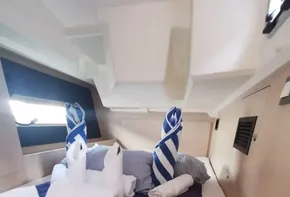 Cozy cabin interior of 2020 Beneteau Oceanis 46.1 yacht with neatly arranged towels.