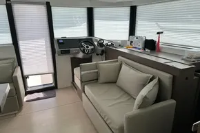 Interior of 2025 Robertson and Caine Leopard 46 Powercat, featuring modern helm and seating area.