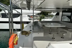 2021 Leopard 50 yacht deck with seating and table, docked at marina.