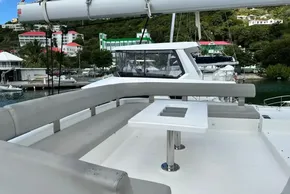 Luxury Leopard 50 yacht deck with seating and table, docked in a scenic marina.