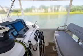 Interior of a 2022 Leopard 50 catamaran cockpit with navigation controls and seating.