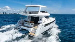 2025 Leopard 40 Powercat cruising on open sea under clear blue sky.