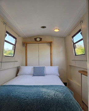 Double bed showing wardrobe and shelves