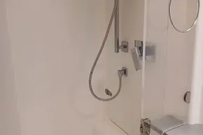 Modern shower area in 2017 Leopard 48 yacht, featuring sleek chrome fixtures.
