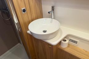 Modern bathroom sink in 2024 Piper 12c, featuring sleek design and wooden accents.