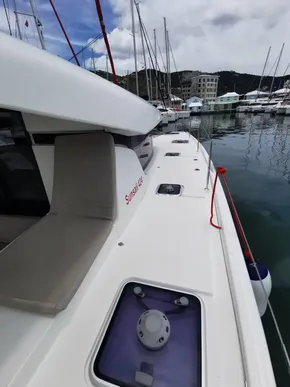 2020 Lagoon 42 catamaran docked in marina, showcasing sleek deck design and modern features.