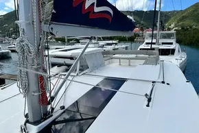 2021 Leopard 50 yacht docked in a scenic marina with lush hills.