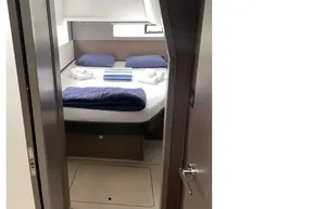 Interior cabin of 2022 Leopard 45 yacht with cozy bed and skylight.