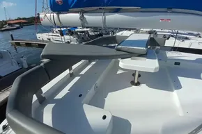 2022 Leopard 45 catamaran deck with seating and table, docked at marina.