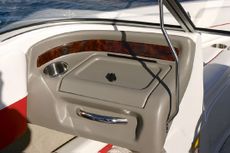 Crownline Bowrider 190 LS Passenger console has a stainless steel cupholder and grab handle. Shown with optional Woodgrain trim.