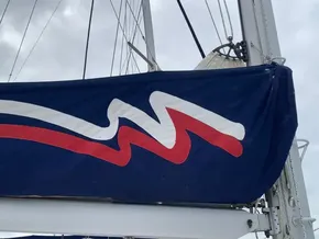 Sail cover on a 2021 Leopard 45 catamaran with red and white design.