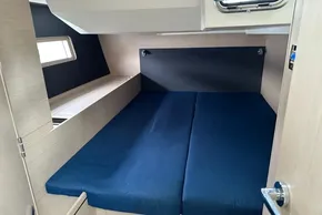 2023 Beneteau Oceanis 51.1 cabin interior with blue bedding and modern design.