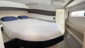 Modern bedroom interior in a 2020 Leopard 50 yacht with a large bed and natural light.