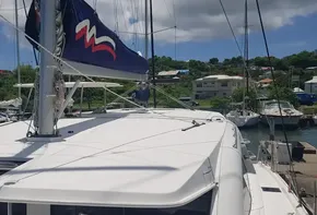 Leopard 48 catamaran, 2017 model, docked at a marina under a sunny sky.
