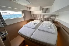 Luxurious cabin interior of 2024 Lagoon 42 catamaran with sea view.