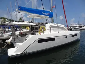 2021 Leopard 40 catamaran docked at marina, featuring blue sail and modern design.