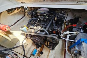 Engine compartment of a 1998 Maxum 2400 SCR boat, showing detailed mechanical components.