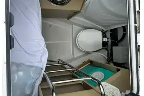 Interior view of 2023 Beneteau Oceanis 51.1 yacht cabin with bed and storage.