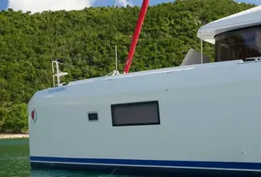 Side view of 2020 Lagoon 42 catamaran on calm water.