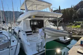 2024 Leopard 40 Powercat yacht docked, featuring spacious deck and inflatable dinghy.