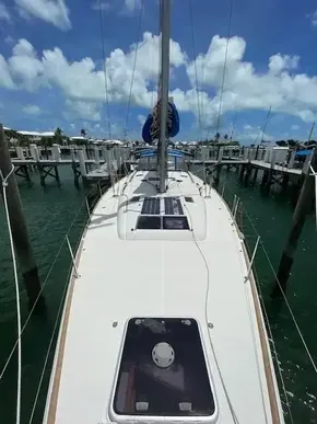 2017 Jeanneau Sun Odyssey 519 sailboat docked at marina under blue sky.