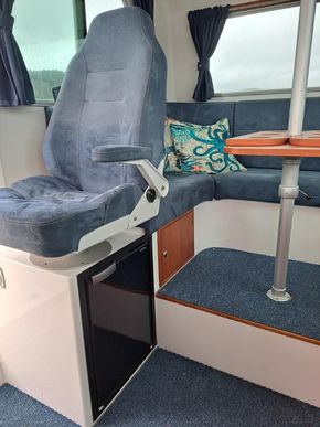 Helm seat with second fridge below