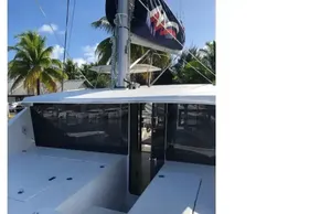 2020 Leopard 40 catamaran with sleek deck design, docked near palm trees.