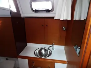 2017 Jeanneau Sun Odyssey 389 bathroom with sink and storage cabinets.