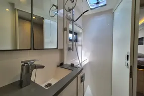 Modern bathroom interior in a 2021 Leopard 45 yacht, featuring sleek fixtures and ample lighting.