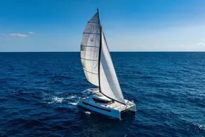 Sailing catamaran Leopard 46, 2025 model, cruising on open ocean under clear blue sky.