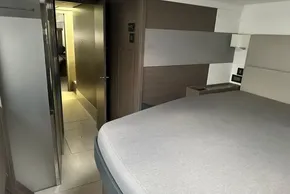 Interior cabin of 2022 Leopard 53 Powercat yacht, featuring modern design and comfortable bedding.